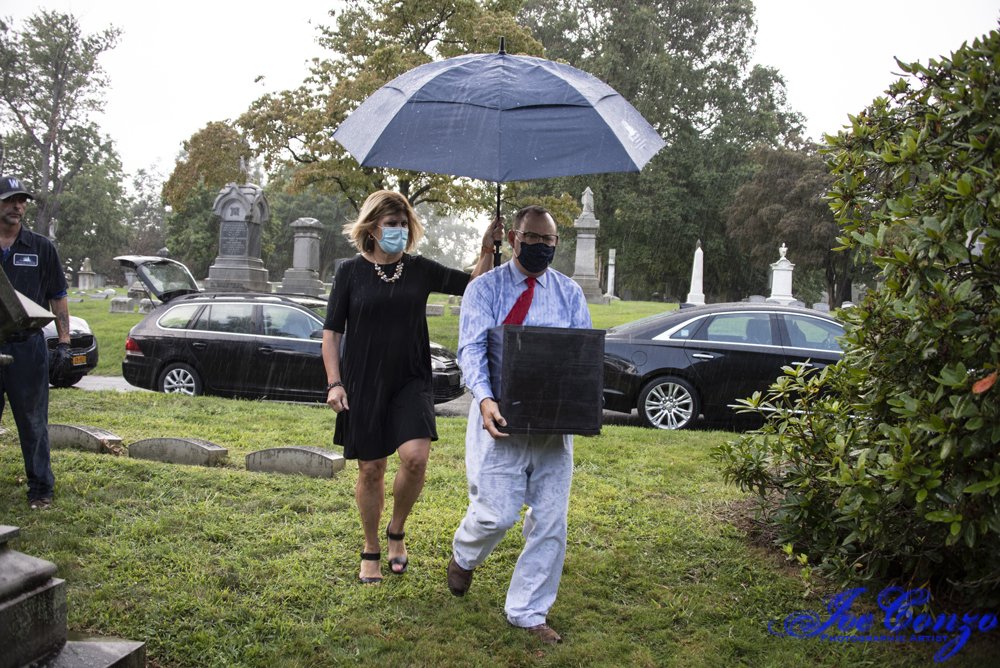 Kevin C. Fitzpatrick brings box with urn to family plot at Woodlawn with Barbary Selesky, marketing director.