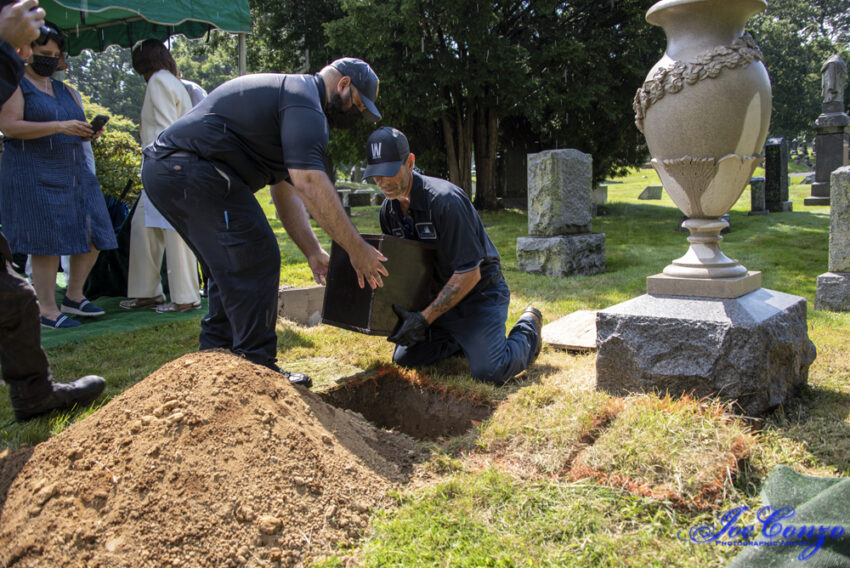 Urn placed in grave by staff. Credit: Joe Conzo, Jr.