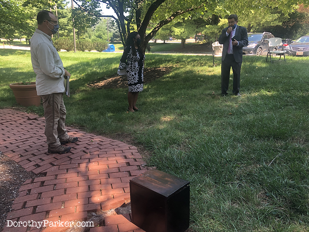 NAACP conducts socially distance ceremony after urn removed from ground.