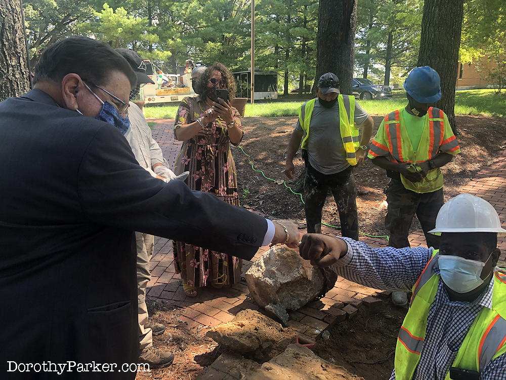 Rabbi Herman congratulates Robert Harris, foreman, on a job well done to remove the urn.